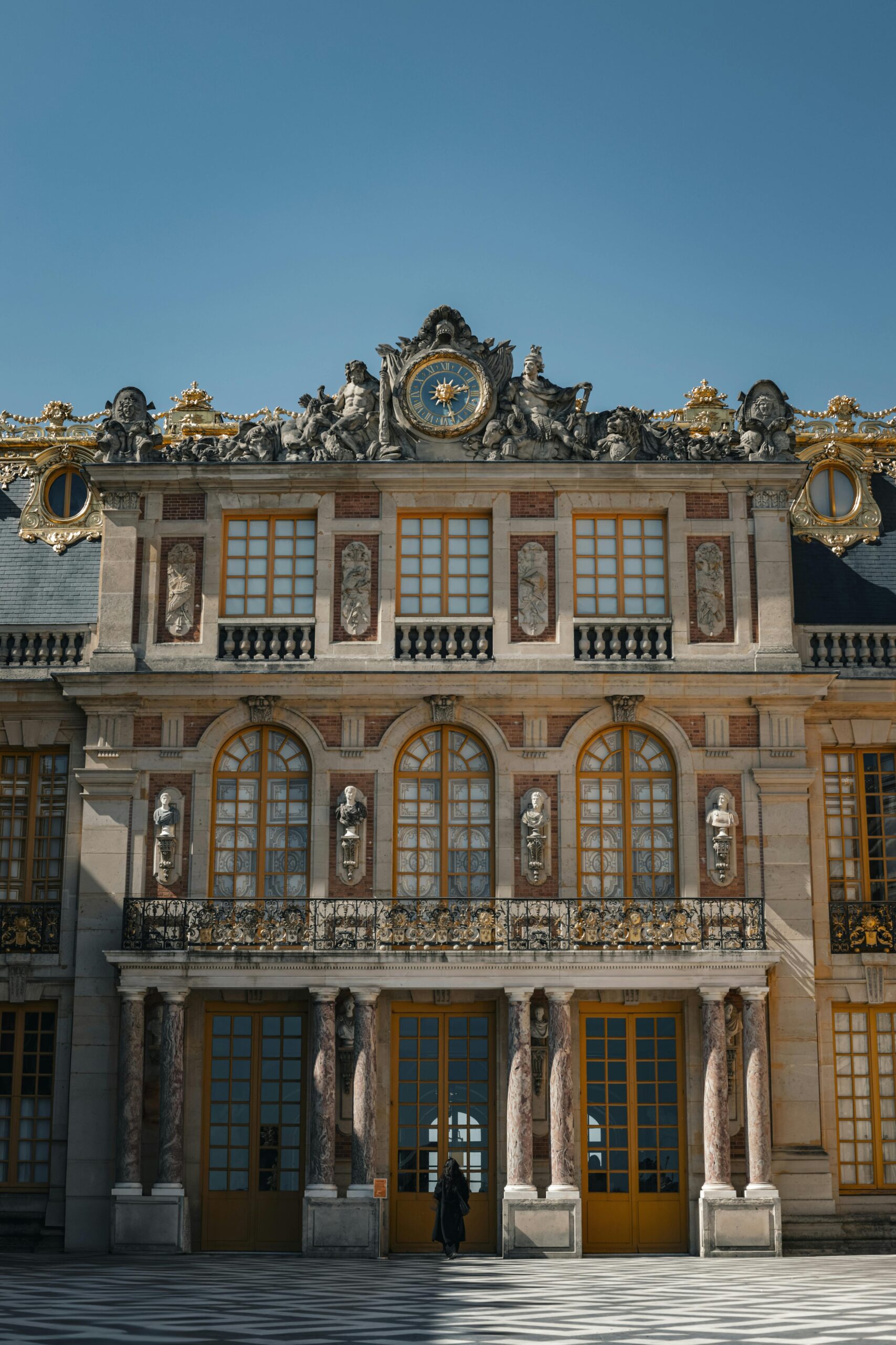 pexels-photo-31596017-31596017 Stunning view of the ornate Versailles Palace facade with a blue sky backdrop.