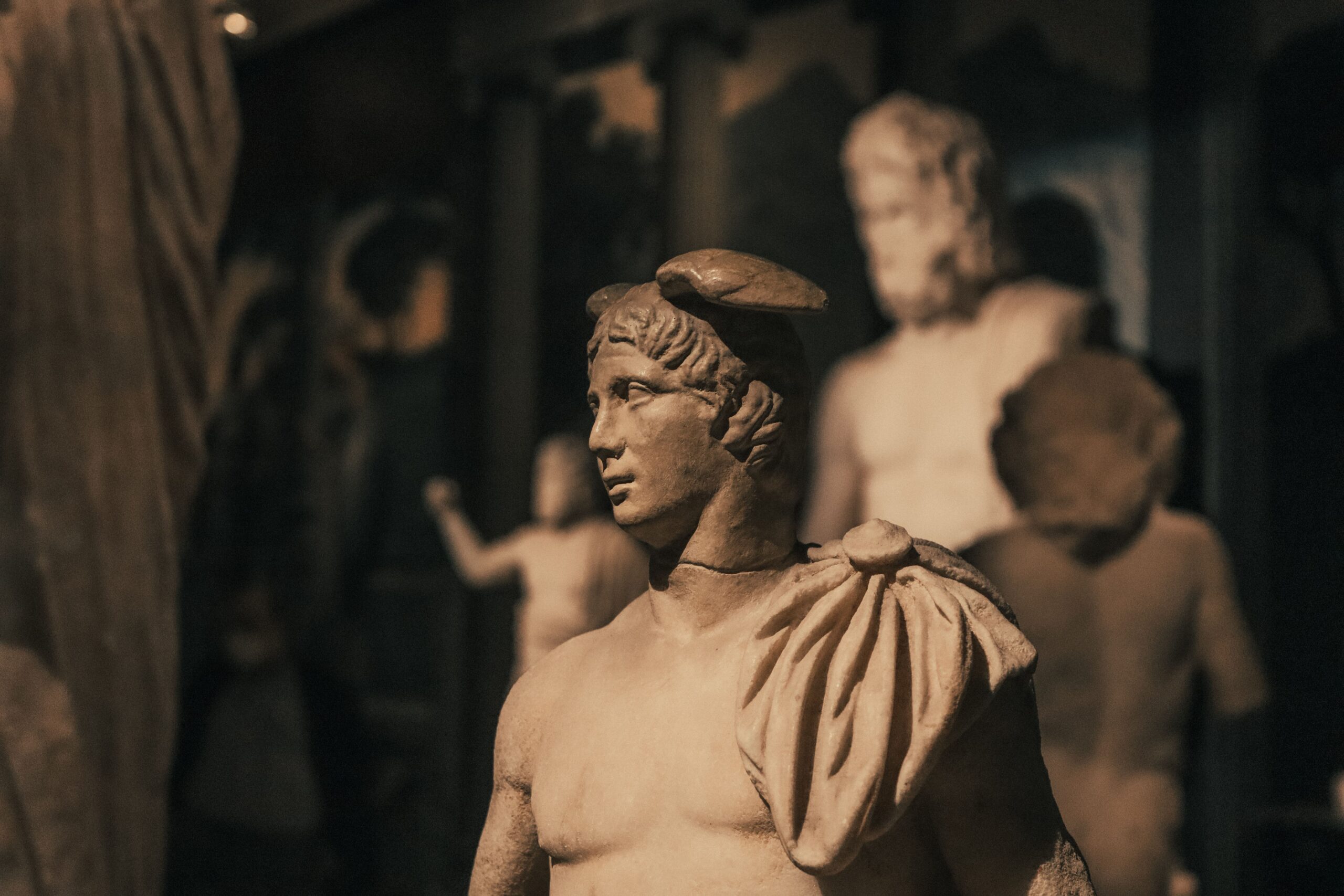 Close-up of ancient Greek-Roman statue in a museum, showcasing classical artistry.
